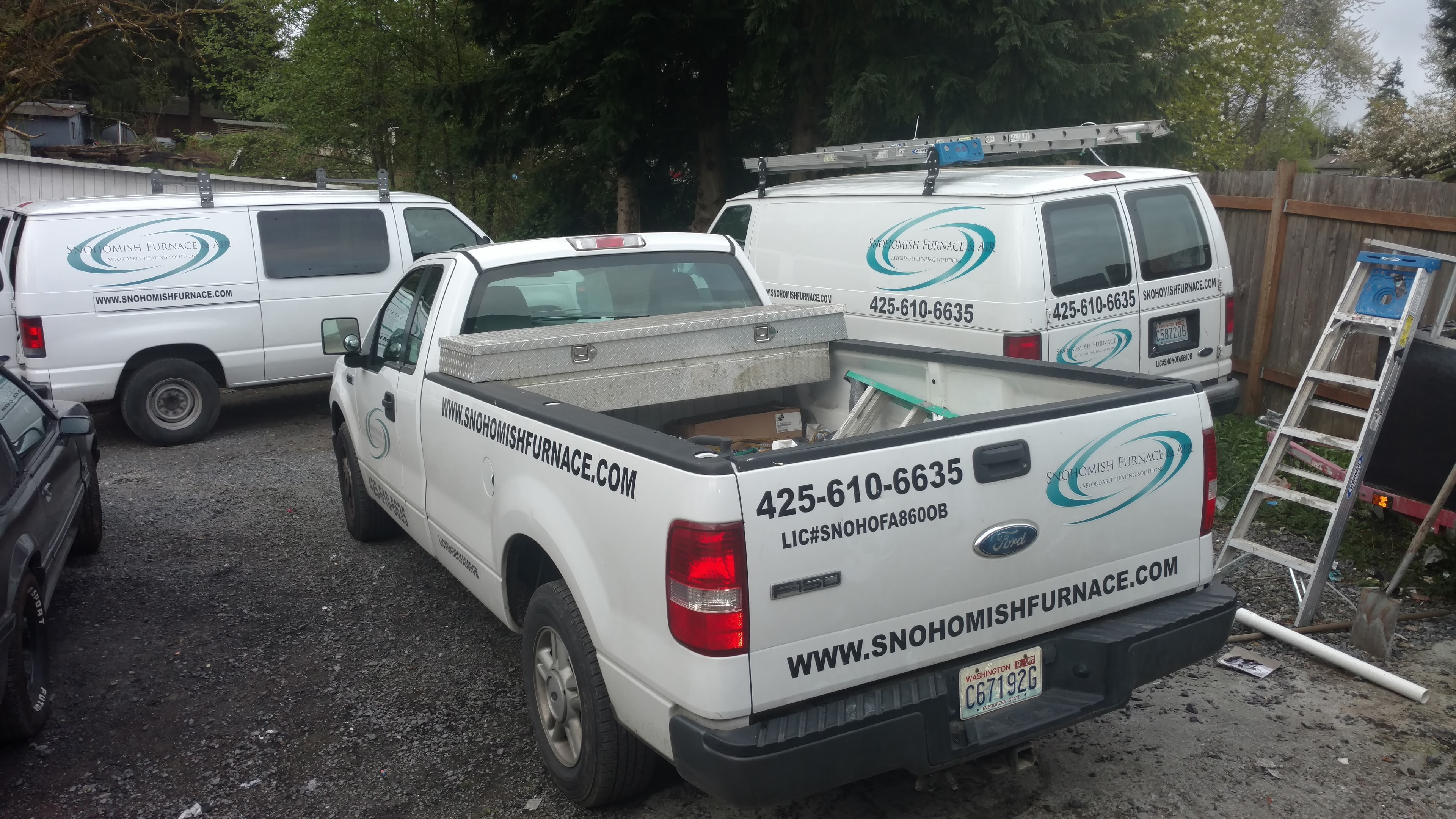 Snohomish Furnace & Air fleet — Ford F-150 service truck and two branded vans in yard, Snohomish County WA HVAC company