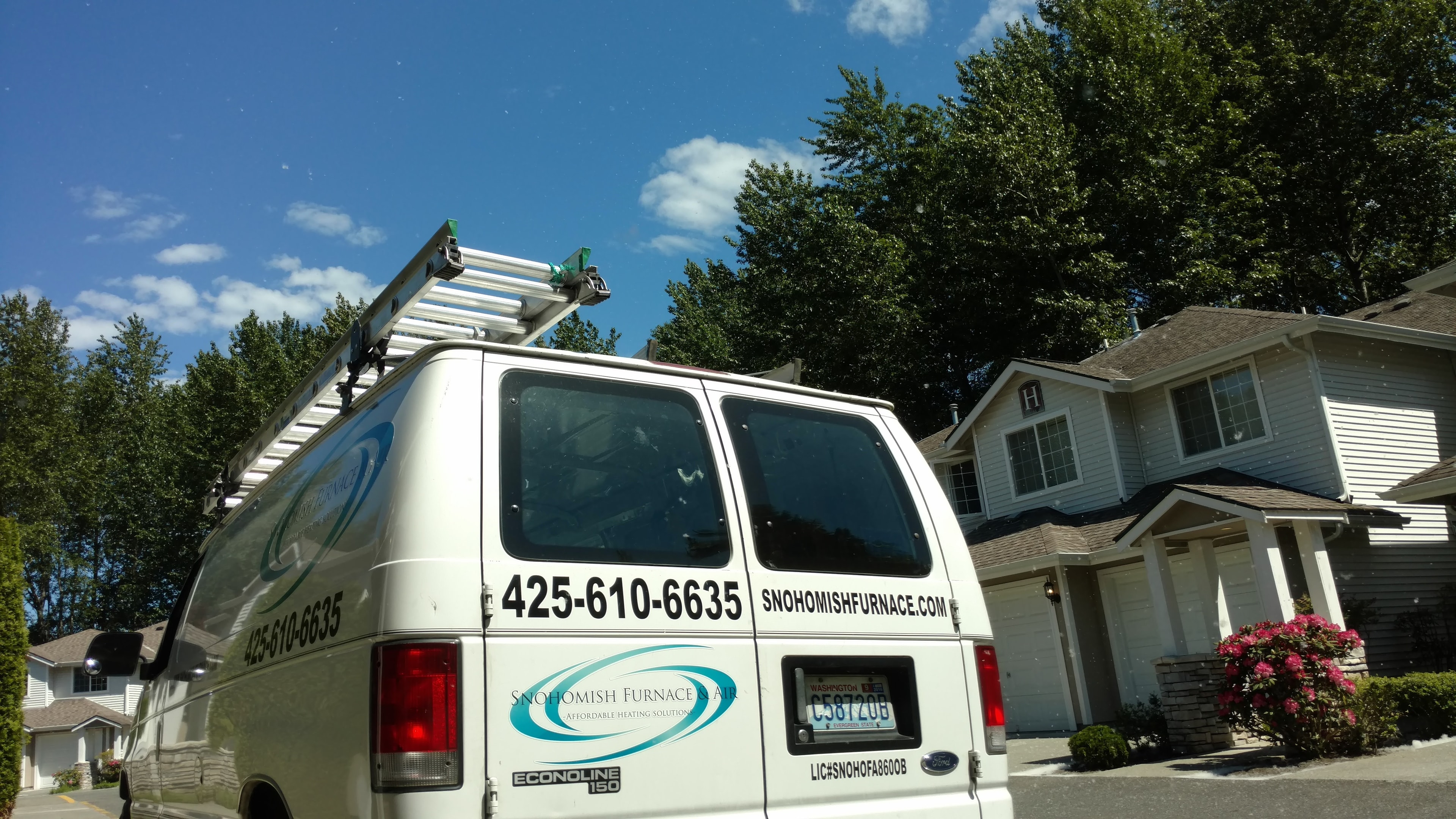 Snohomish Furnace & Air Ford Econoline service van parked at a residential home on a sunny day — local HVAC service call